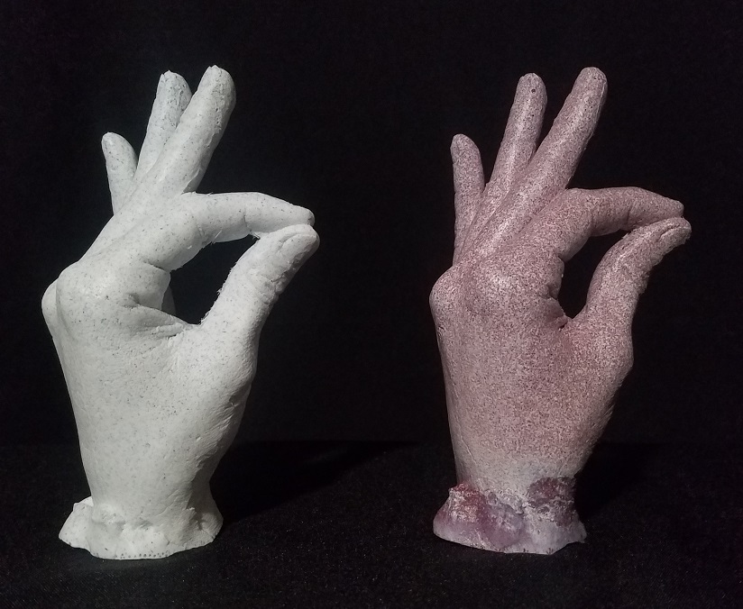 2 casts of female hand with a granite look:cherry read and light blue
