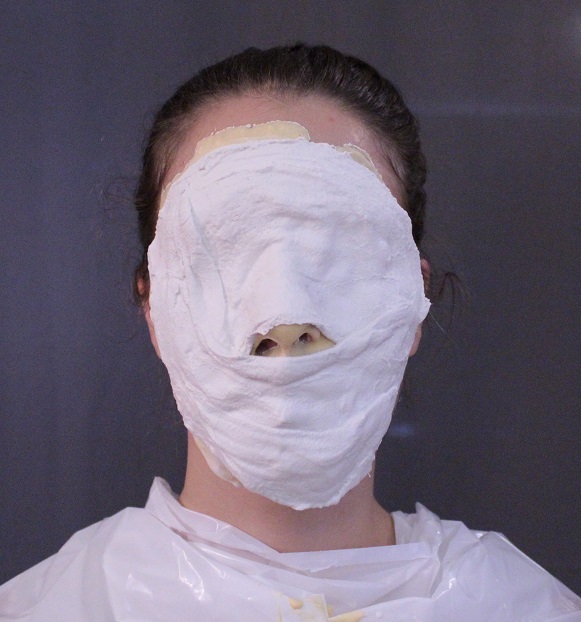 model face covered with plaster